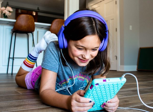 Child reading on a tablet Child reading on a tablet